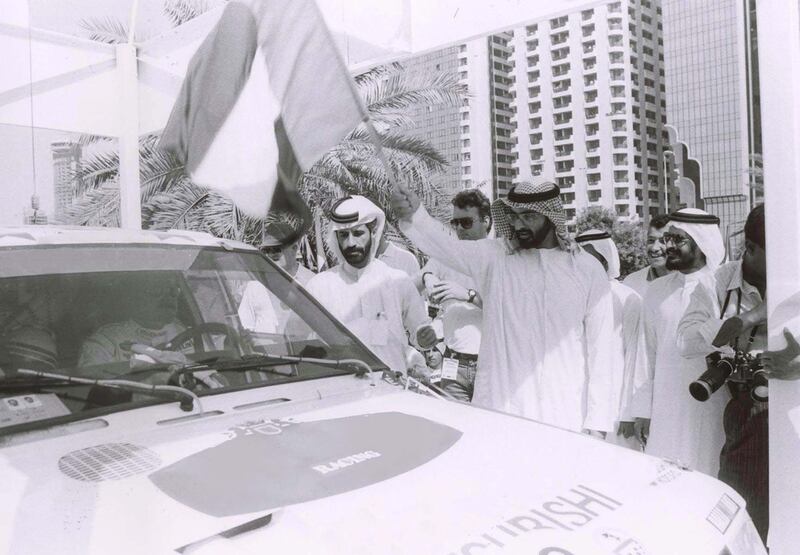 Sheikh Mohammed bin Zayed Al Nahyan, the Crown Prince of Abu Dhabi and Deputy Supreme Commander of the Armed Forces, waving the flag to mark the start of the first Desert Challenge stage that took place in Abu Dhabi, in 1992. Dr Mohammed Ben Sulayem is also seen on the left. Photo Courtesy / ATCUAE