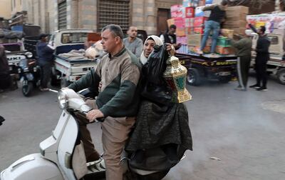 A woman carries home a traditional Ramadan lantern in Cairo. EPA