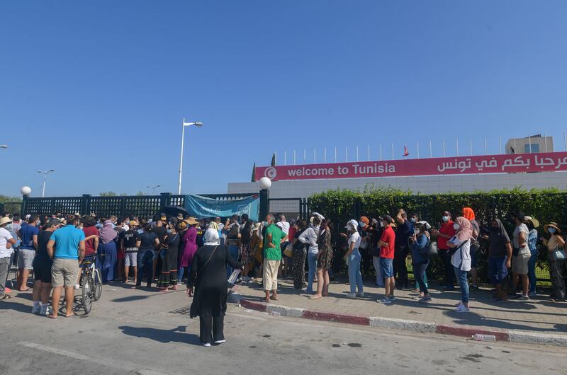 Tunisians wait to receive a dose of the Sinopharm vaccine outside the Palais des Congres in the capital, Tunis.