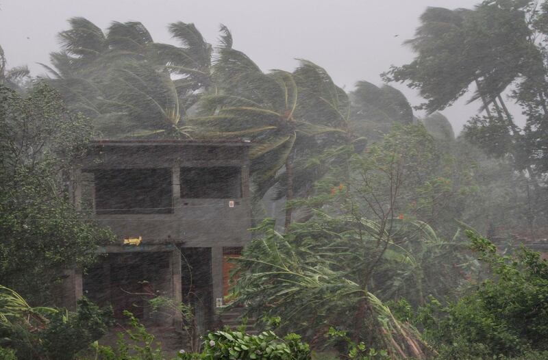 An abandoned house and trees bend with winds ahead off the landfall of Cyclone Fani. AP Photo
