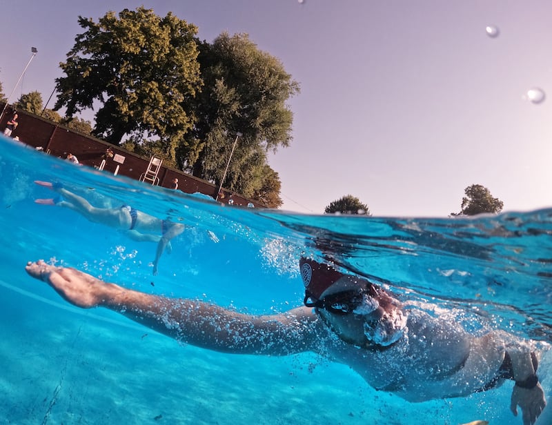 A swimmer takes an early morning dip in the cool water of Jesus Green Lido in Cambridge, eastern England. Getty Images