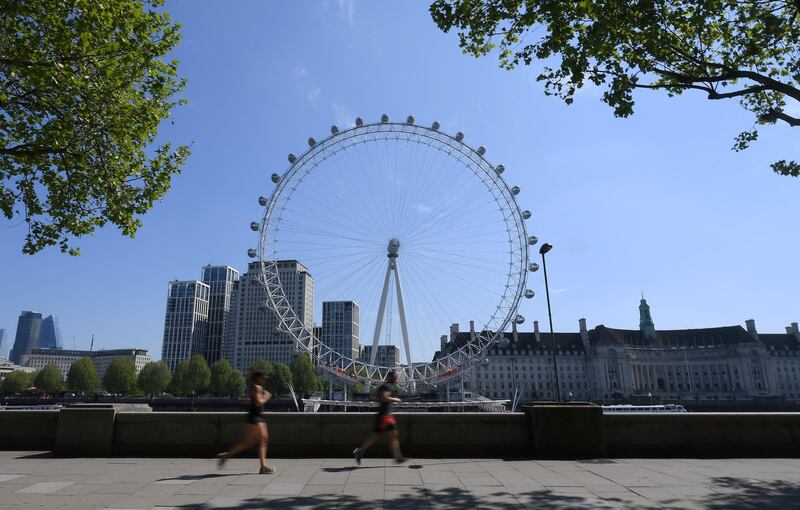 LONDON, ENGLAND - APRIL 26: The London Eye is seen from the Embankment  as runners go past on April 26, 2020 in London, England. The 40th London Marathon was due to take place today, with thousands of runners due to take part. It has postponed until October 04 due to the coronavirus (COVID-19) outbreak.  (Photo by Alex Davidson/Getty Images)