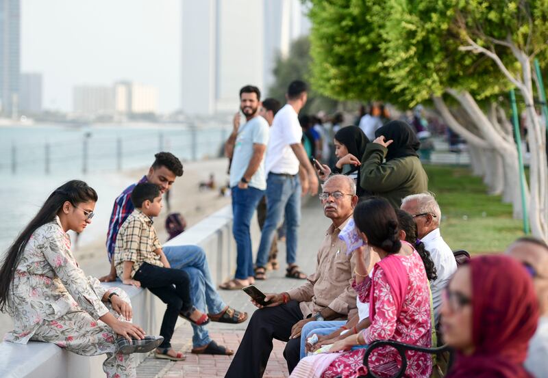 Families spend time at the corniche in Abu Dhabi. Khushnum Bhandari / The National