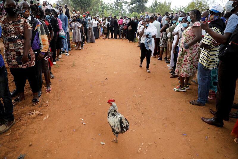 Voters queue to cast their ballots in the presidential elections outside a voting center in Kampala, Uganda. Reuters