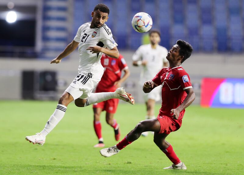 UAE's Harib Abdalla and Aashish Chaudhary of Nepal battle for the ball.