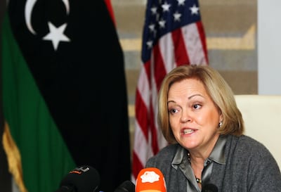 US Ambassador to Libya Deborah Jones speaks after signing a trade and investment framework agreement with Libya's Economy Minister Mustapha Abu Fonas (unseen), in the Libyan capital Tripoli, on December 18, 2013. AFP PHOTO/MAHMUD TURKIA (Photo by MAHMUD TURKIA / AFP)