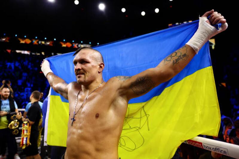 Oleksandr Usyk celebrates with the flag of Ukraine. Getty