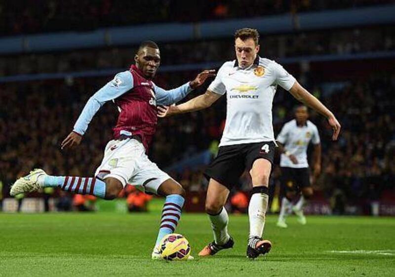 Christian Benteke, left, of Aston Villa is closed down by Jonny Evans of Manchester United during their Premier League match at Villa Park on December 20, 2014 in Birmingham, England. (Photo by Michael Regan/Getty Images)