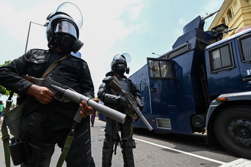 Police personnel stand guard outside the president's office. AFP