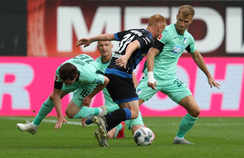 Paderborn midfielder Sebastian Vasiliadis (C) vies with Hoffenheim midfielder Sebastian Rudy (L) and defender Stefan Posch. AFP