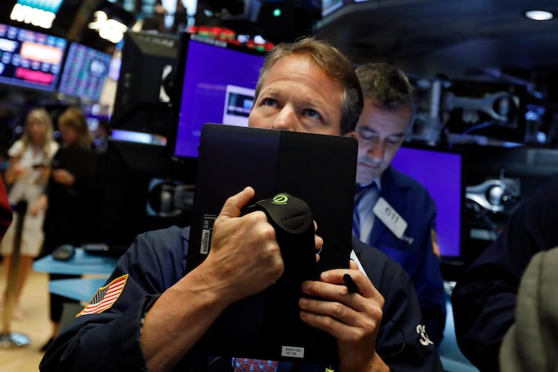FILE - In this May 17, 2019, file photo trader Robert Charmak works on the floor of the New York Stock Exchange. An unexpected escalation in the trade war between the U.S. and China jolted investors into a defensive position in May. (AP Photo/Richard Drew, File)