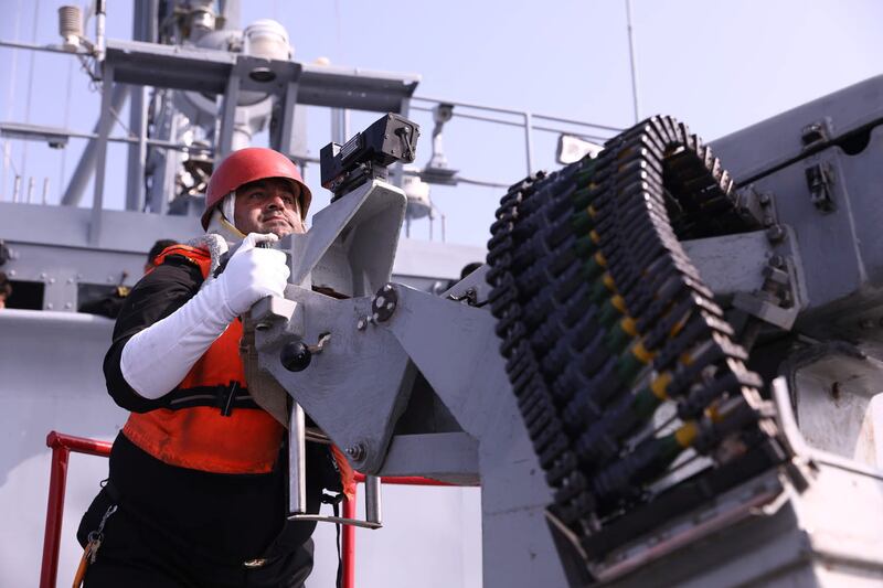 An Iranian sailor prepares to fire a weapon during the joint exercise.
