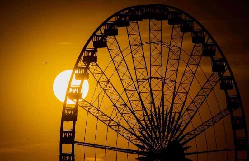 The Ferris wheel of the Rhein fun fair is pictured at sunset in Duesseldorf, western Germany. Jana Bauch/AFP