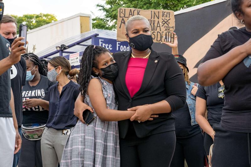 Georgia state representative Erica Thomas hugs her daughter while listening to speakers speak before marching through the streets after the verdict was announced for Derek Chauvin in Atlanta. AFP