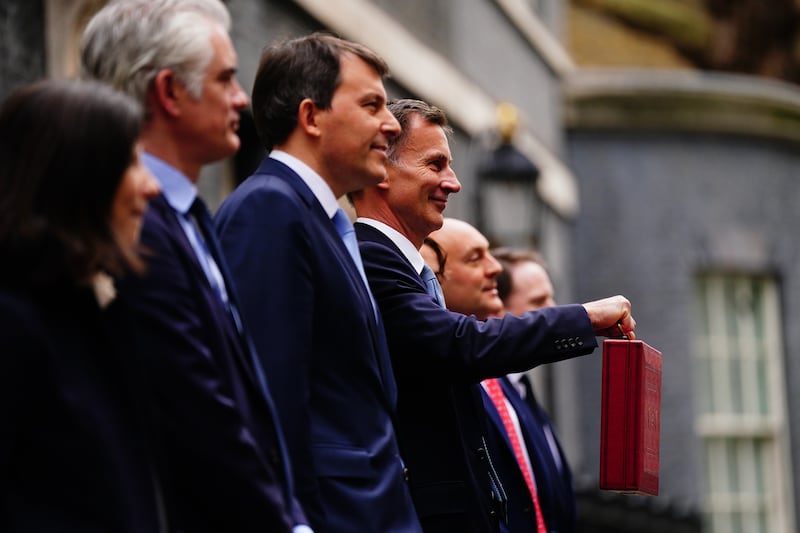 Chancellor Jeremy Hunt holds his ministerial red box outside 11 Downing Street before delivering his 2023 Budget. All photos: Getty Images