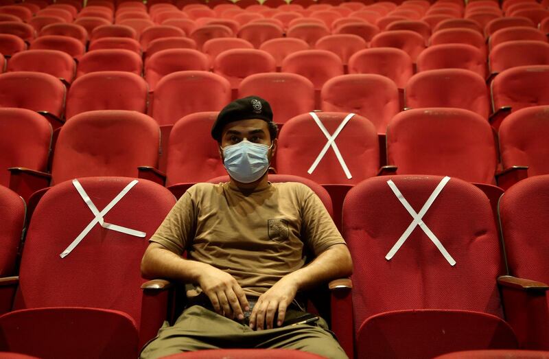 A police officer waits his turn to receive the Convidecia COVID-19 vaccine at a vaccination center in the Nishtar hall in Peshawar, Pakistan, Friday, June 11, 2021. (AP Photo/Muhammad Sajjad)