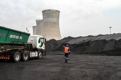 A worker supervises as a truck delivers coal supplies to the coal yard at the Grootvlei power station, operated by Eskom Holdings SOC Ltd., in Grootvlei, South Africa, on Monday, Nov. 3, 2014. Eskom said South Africa's power supply remains strained as it investigates what caused a silo storing coal to collapse, forcing the state-owned utility to cut electricity to customers. Photographer: Dean Hutton/Bloomberg