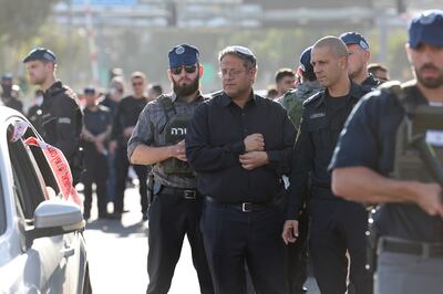 Israeli National Security Minister Itamar Ben-Gvir with security officials. The far-right minister has called for the war to continue and Israel to re-occupy Gaza. EPA

