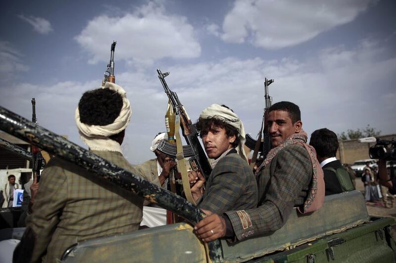 Tribesmen loyal to the Houthi rebels ride on a pickup truck during a gathering aimed at mobilising more fighters. Hani Mohammed / AP