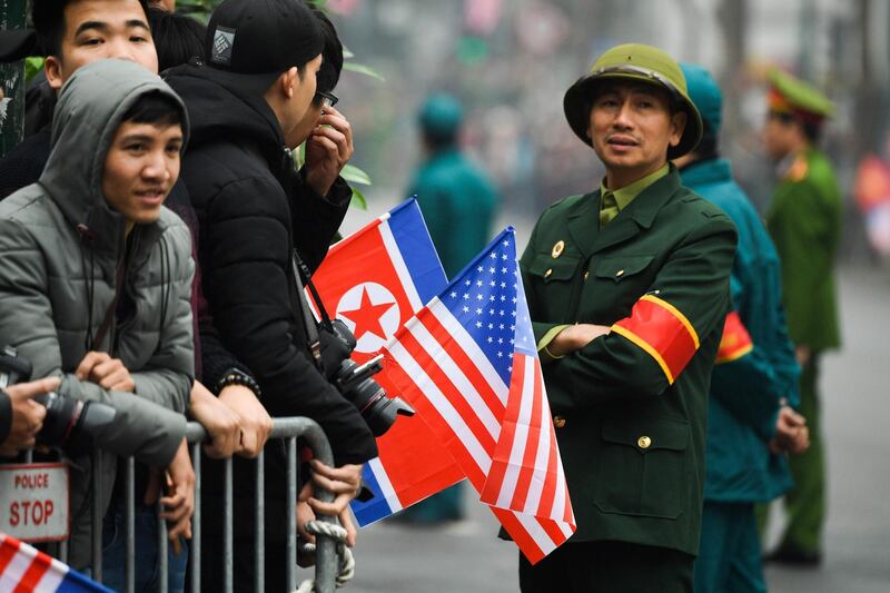 People wait behind barricades for the arrival of Kim Jong-un. AFP