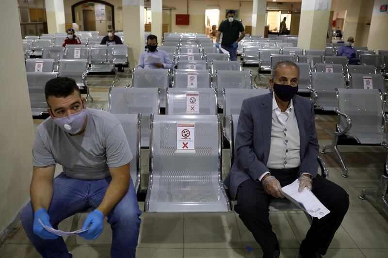 People complete their transactions in the Civil Status Department after Jordan's public sector employees returned gradually to work in Amman. Reuters