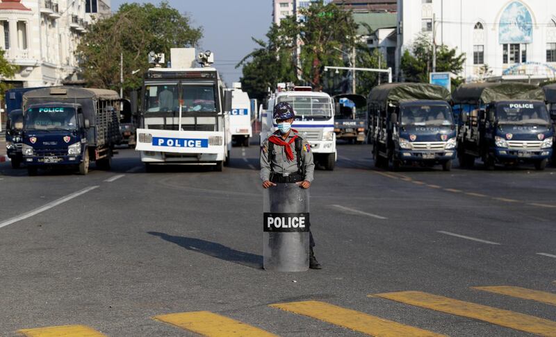 A policeman holding a shield stands guard in front of Yangon City Hall during a protest against the military coup in Yangon, Myanmar. EPA