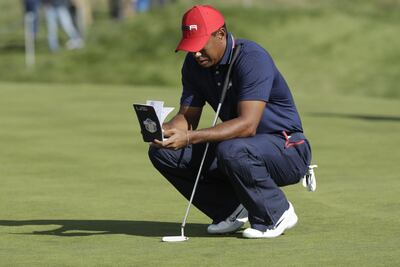 US golfer Tiger Woods looks at a notepad on the third day of the 42nd Ryder Cup at Le Golf National Course at Saint-Quentin-en-Yvelines, south-west of Paris, on September 30, 2018.  / AFP / Geoffroy VAN DER HASSELT
