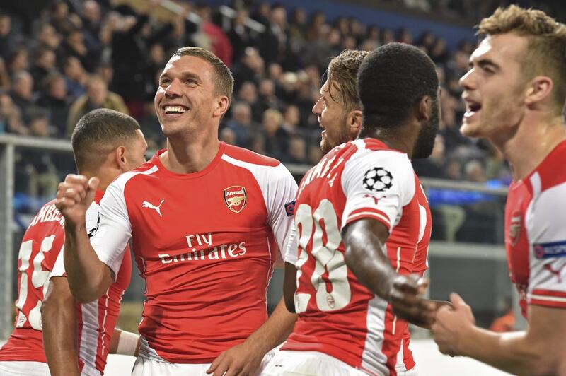 Arsenal's Lukas Podolski, second left, celebrates after scoring Arsenal's winner in a 2-1 Champions League victory over Anderlecht on Wednesday night in Brussels. Geert Vanden Wijngaert / AP / October 22, 2014