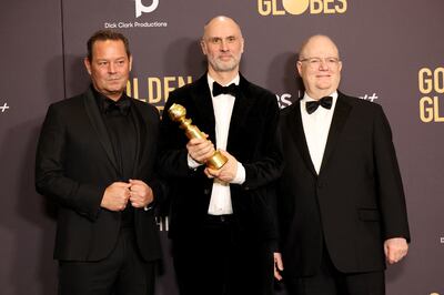 Succession creator Jesse Armstrong (centre) poses with the award for Best Television Series - Drama, with producers Kevin J Messick and Frank Rich. Reuters