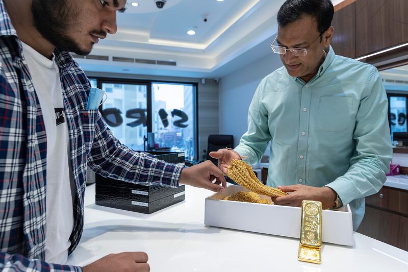 A jeweller examines a necklace at Siroya Jewellers in Dubai.

