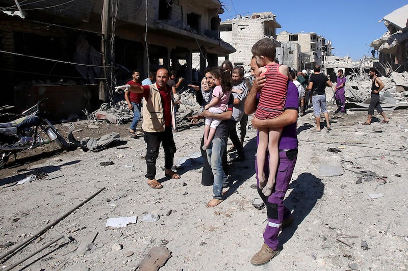 Syrian civilians flee an area targeted by a Russian air strike on Maaret Al Numan.  AFP