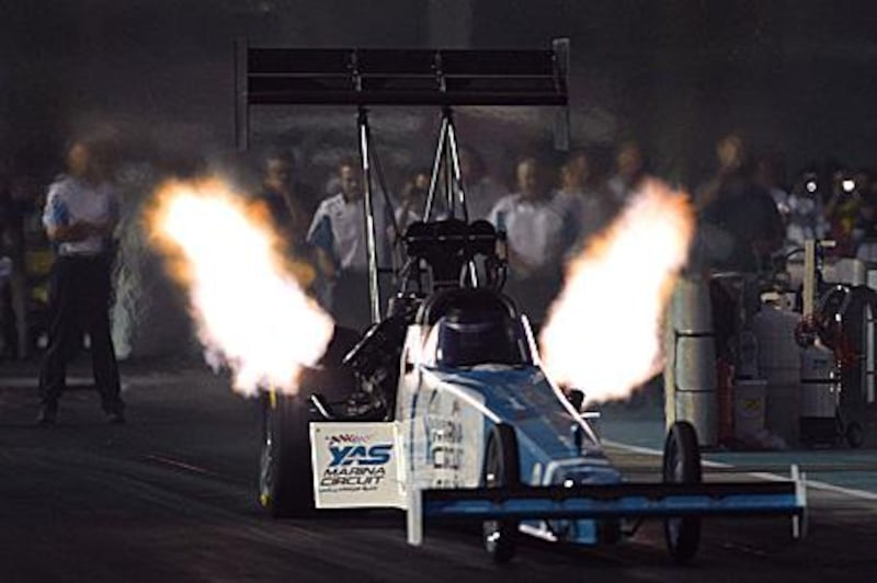 Rod Fuller, a leading  American driver, roars into action in  the Top Fuel Dragsters event.