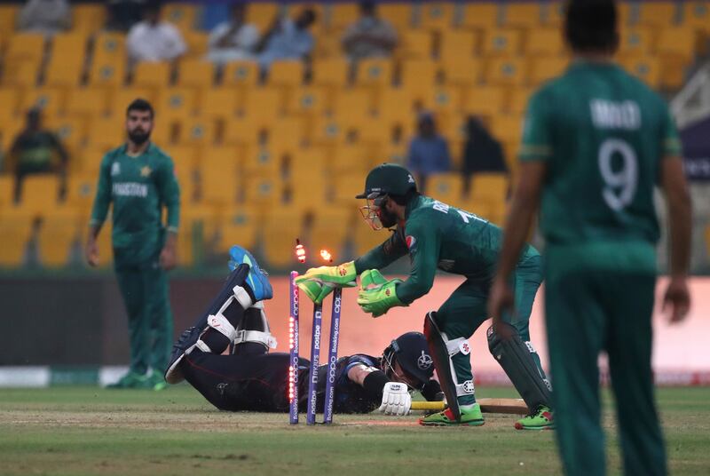Pakistan's wicketkeeper Mohammad Rizwan, second right, runs out Namibia's Stephan Baard. AP