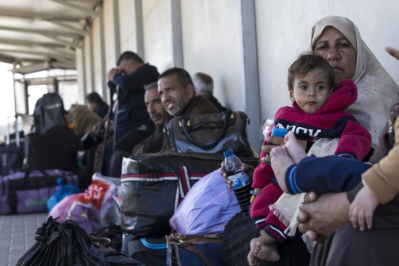 Palestinians wait on the Israeli side of the Erez terminal to cross to Gaza Strip. Tsafrir Abayov / AP Photo