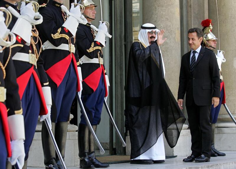 Nicolas Sarkozy, France’s president, right, looks on as Saudi Arabia’s King Abdullah bin Abdulaziz Al Saud, centre, waves from the steps of the Elysee Palace in Paris on June 21, 2007. Judith White / Bloomberg
