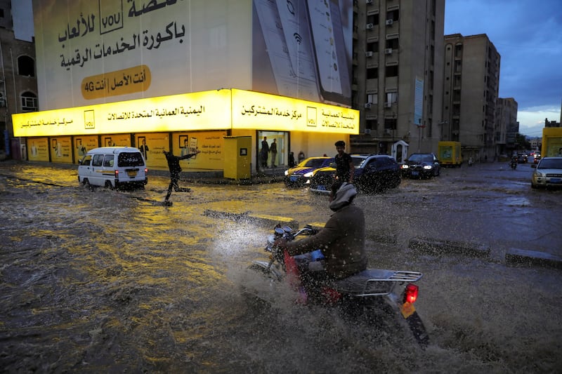 A motorcyclist rides through a flooded street after heavy rain in Sanaa, Yemen. Reuters