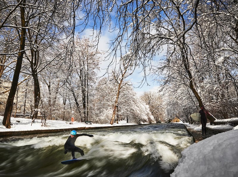 A surfer rides the Eisbach wave in the English Garden in Munich, Germany. Getty Images