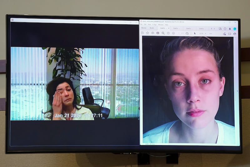 Raquel Pennington becomes emotional in a recorded video deposition, as a picture of Amber Heard is seen on screen. EPA