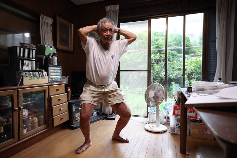 Oshima, 85, stretches at his home in Chigasaki in suburban Tokyo