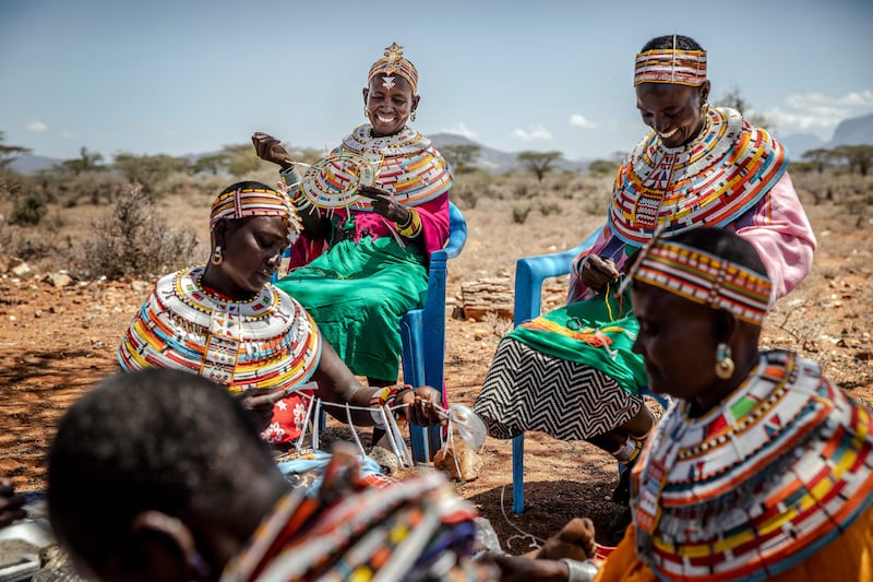 A group of Samburu women work making traditional ornaments and jewelry out of beads in Sera Conservancy, Samburu County, Kenya last year. AFP