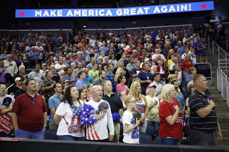 Attendees say the pledge of allegiance during a rally with U.S. President Donald Trump in Evansville, Indiana, U.S., on Thursday, Aug. 30, 2018. Trump rejected a European Union offer to scrap tariffs on cars, likening the bloc's trade policies to those of China. Photographer: Luke Sharrett/Bloomberg