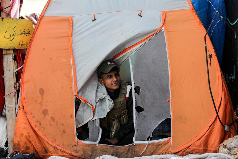 A protester looks out from a tent on the Senak bridge. AFP