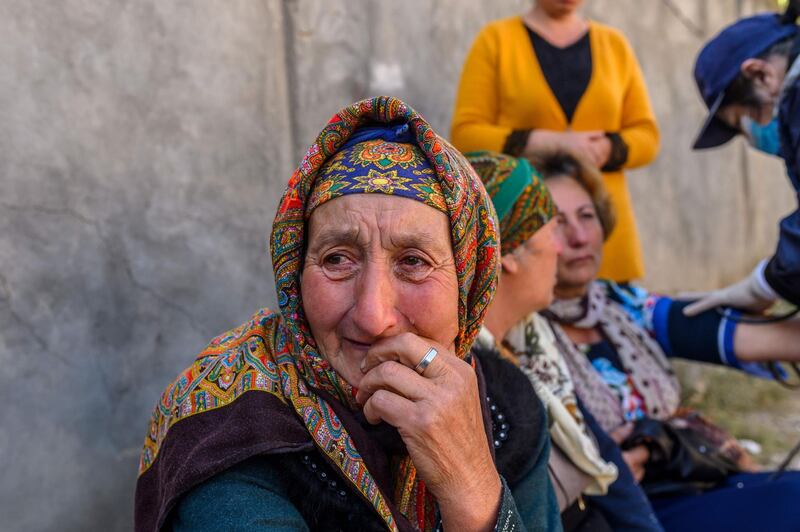 People gather near a site hit by a rocket during fighting over the breakaway region of Nagorno-Karabakh. AFP