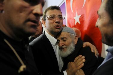 Ekrem Imamoglu, main opposition Republican People's Party (CHP) candidate for mayor of Istanbul, embraces his supporter at his election campaign office in Istanbul. Reuters