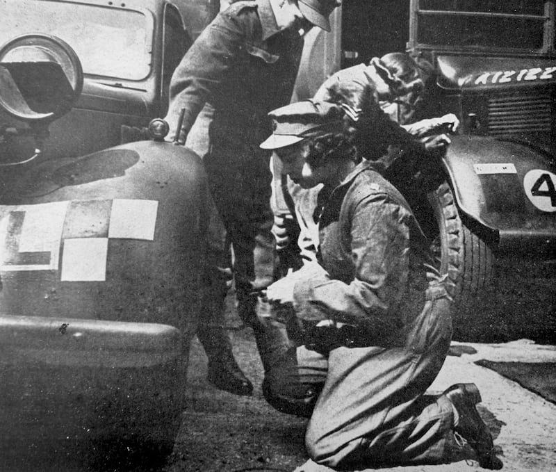 Princess Elizabeth repairs a vehicle during the Second World War. Getty