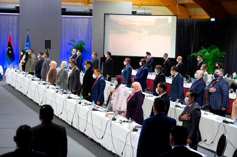 Another view of delegates standing during the national anthem at the opening of the Libyan Political Dialogue Forum. AFP