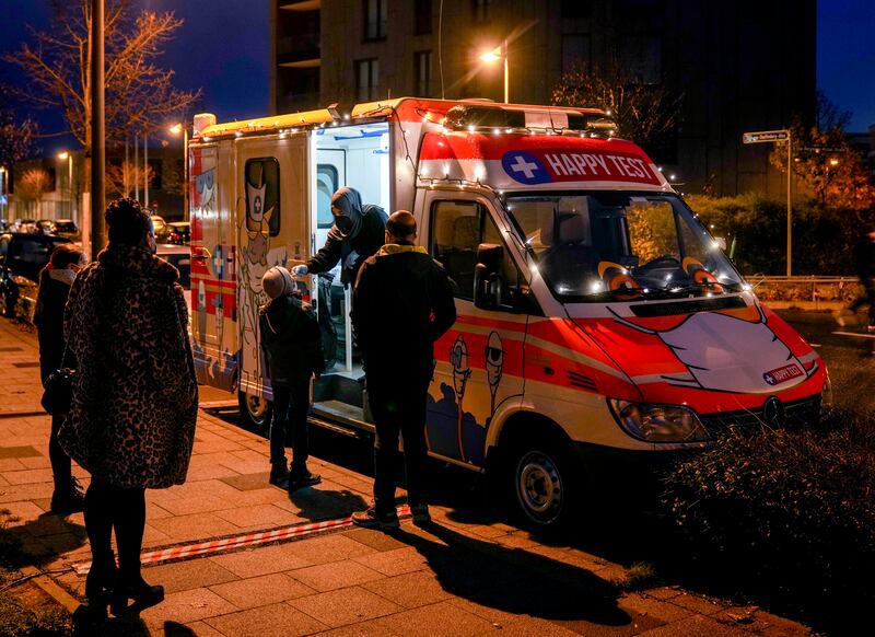 A medical worker carries out a rapid test at a mobile centre in Frankfurt.  AP