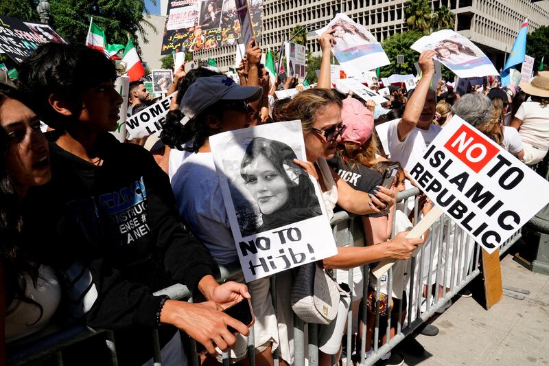 Demonstrators display images of Mahsa Amini at a Freedom Rally for Iran outside City Hall in Los Angeles, California, on October 1, 2022. Reuters