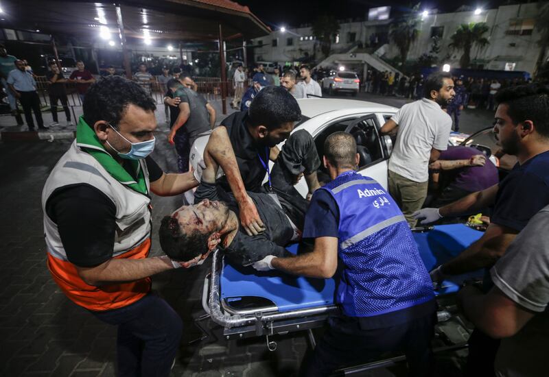 Palestinians carry a wounded man at Al Shifa Hospital in Gaza city. EPA