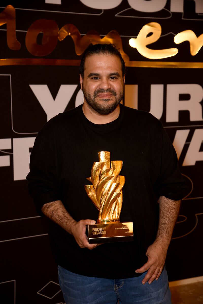 Tawfik Alzaidi poses with the Film AlUla Audience Award for Saudi Film, won for Norah. Getty Images 